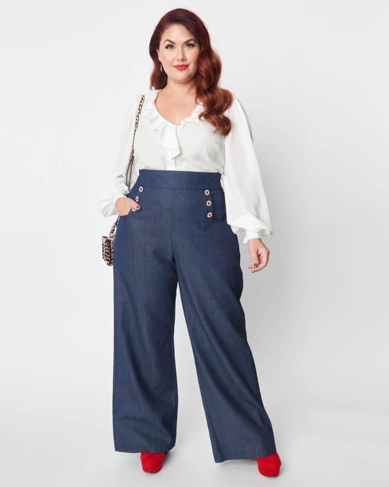 Front of a model wearing a size 4X/22-24 Unique Vintage Plus Size Heart Buttoned Denim High Waist Ginger Jeans in Blue Denim by Unique Vintage. | dia_product_style_image_id:270087